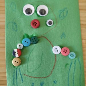 Decorated number 3 with crayon, button and googly eyes